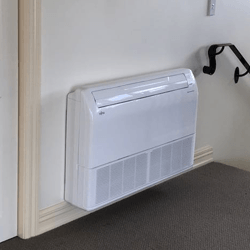 White floor mounted air conditioner near stairs